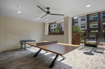 Outdoor pool-side lounge with ping pong table